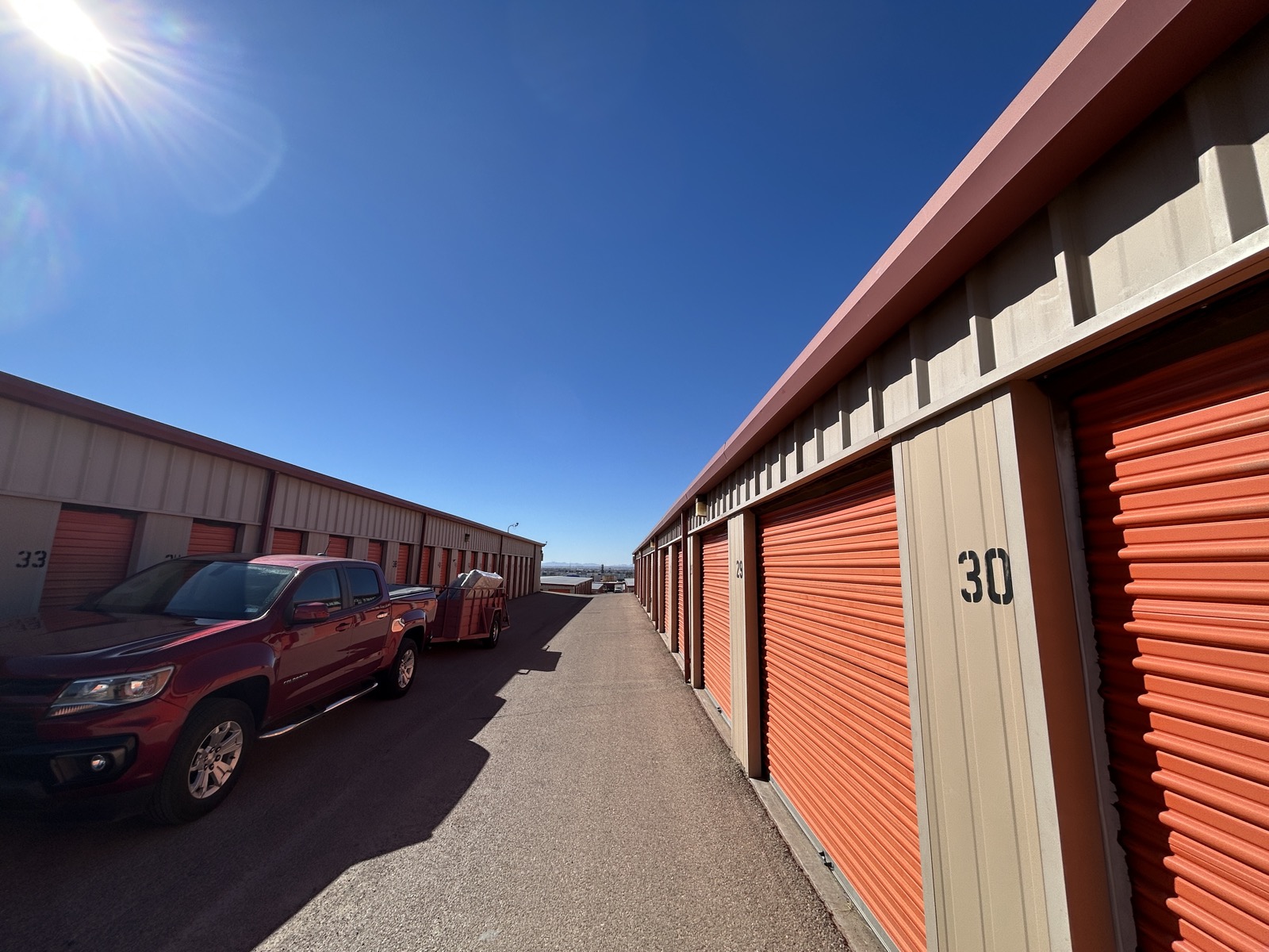 Spacious driveways between storage buildings with truck loading at unit